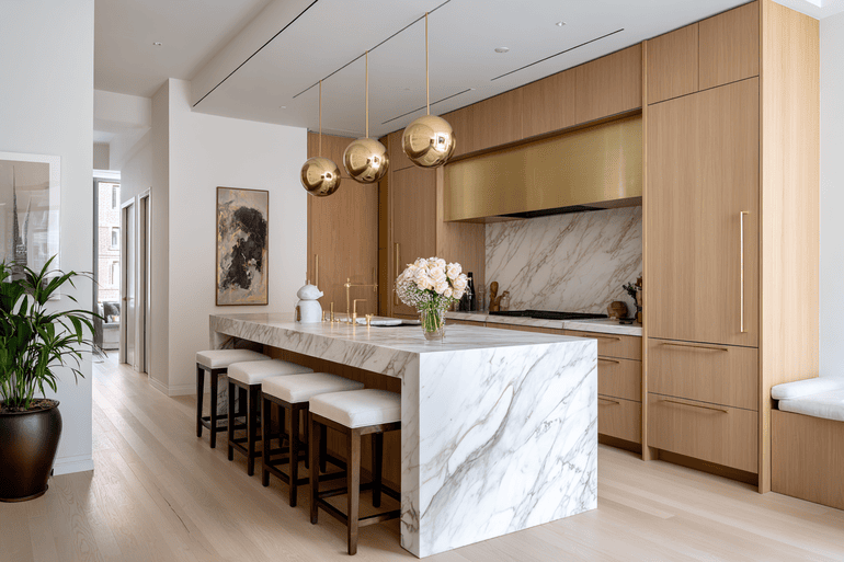 High-end custom kitchen renovation in a NYC apartment with marble countertops and brass details