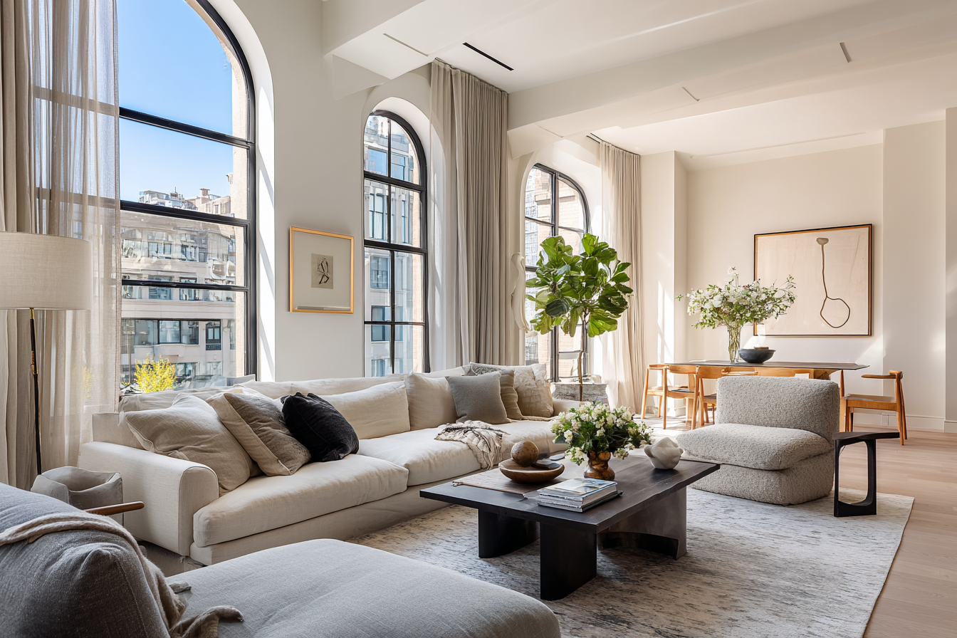 Combined living room in a NYC pre-war apartment showing seamless architectural flow between two merged units