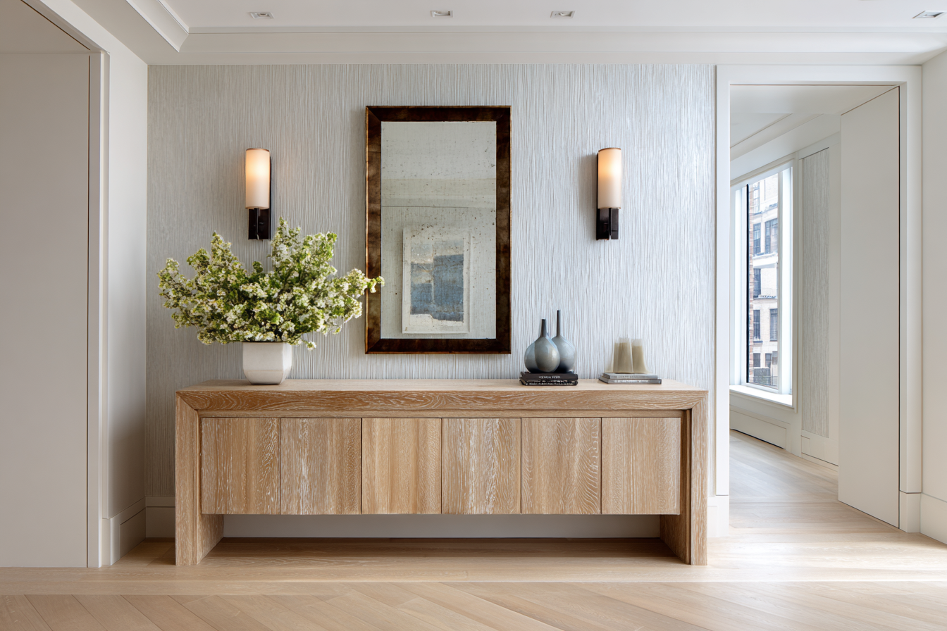 Elegant NYC entryway with integrated smart security features and organic design details, blending discreet technology with upscale style.