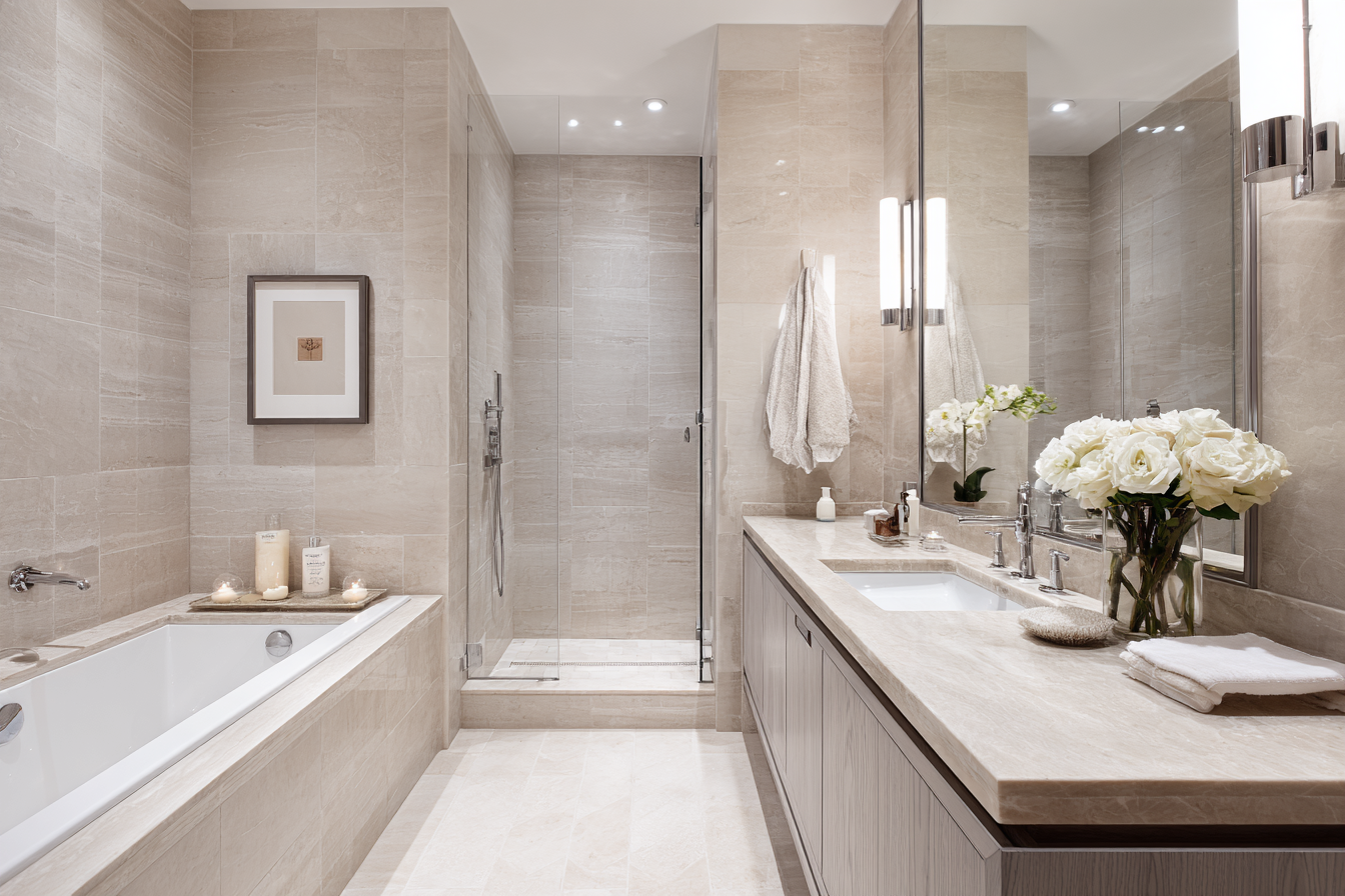 Serene high-end Manhattan bathroom renovation with marble walls and brass fixtures