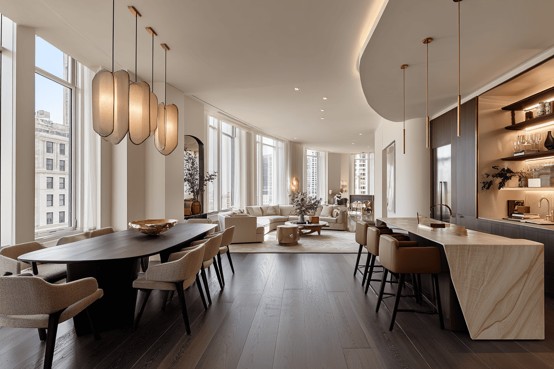 Modern luxury dining room NYC — walnut table, sculptural lighting, and cobalt accent in loft setting