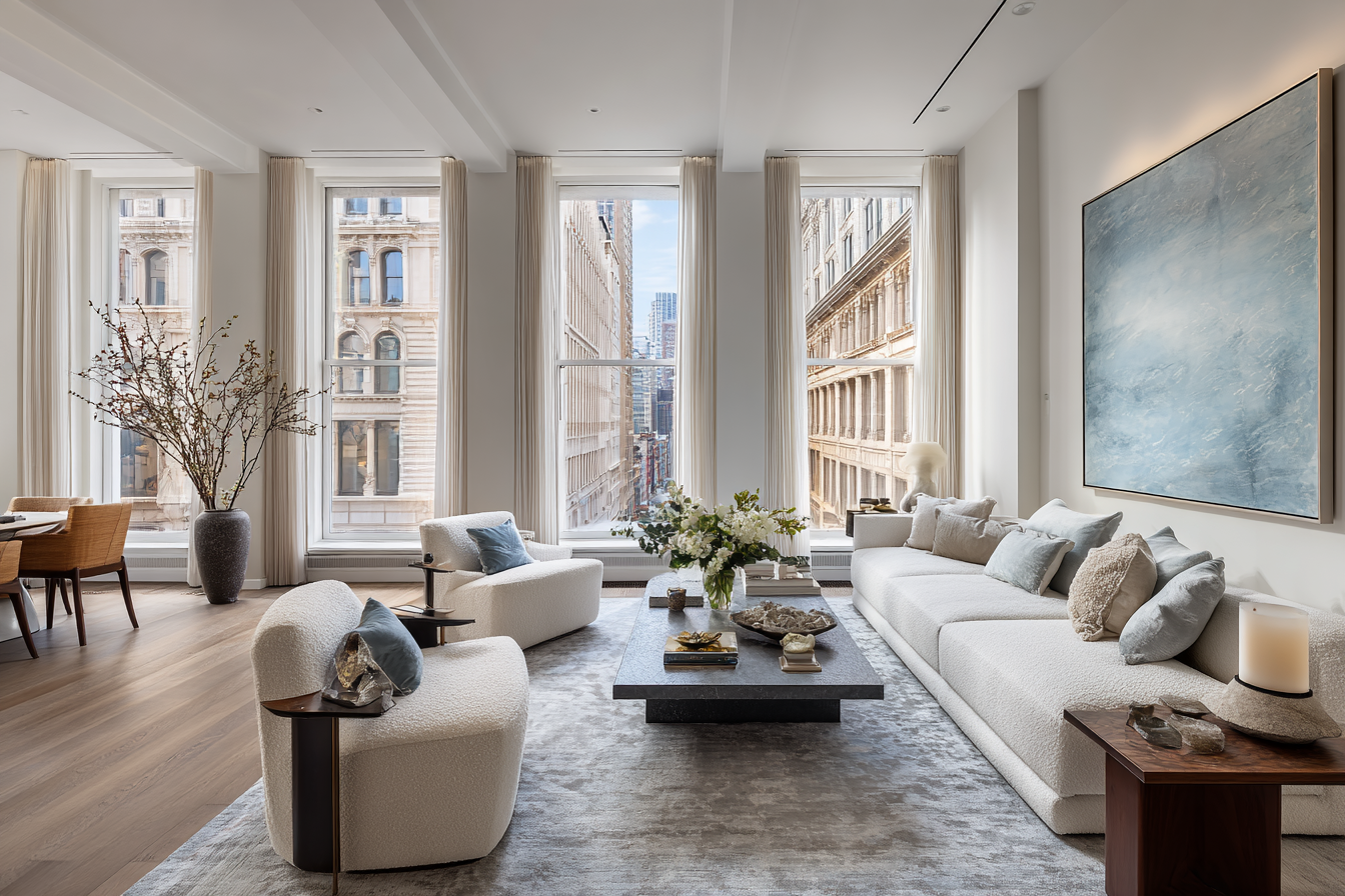 Luxury NYC loft living room with curved boucle sofa, live-edge walnut table, and emerald accent chair