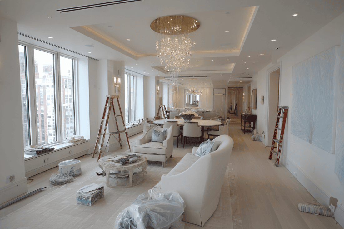 Interior design planning workspace with drawings, finish schedules, and material samples for NYC renovation coordination